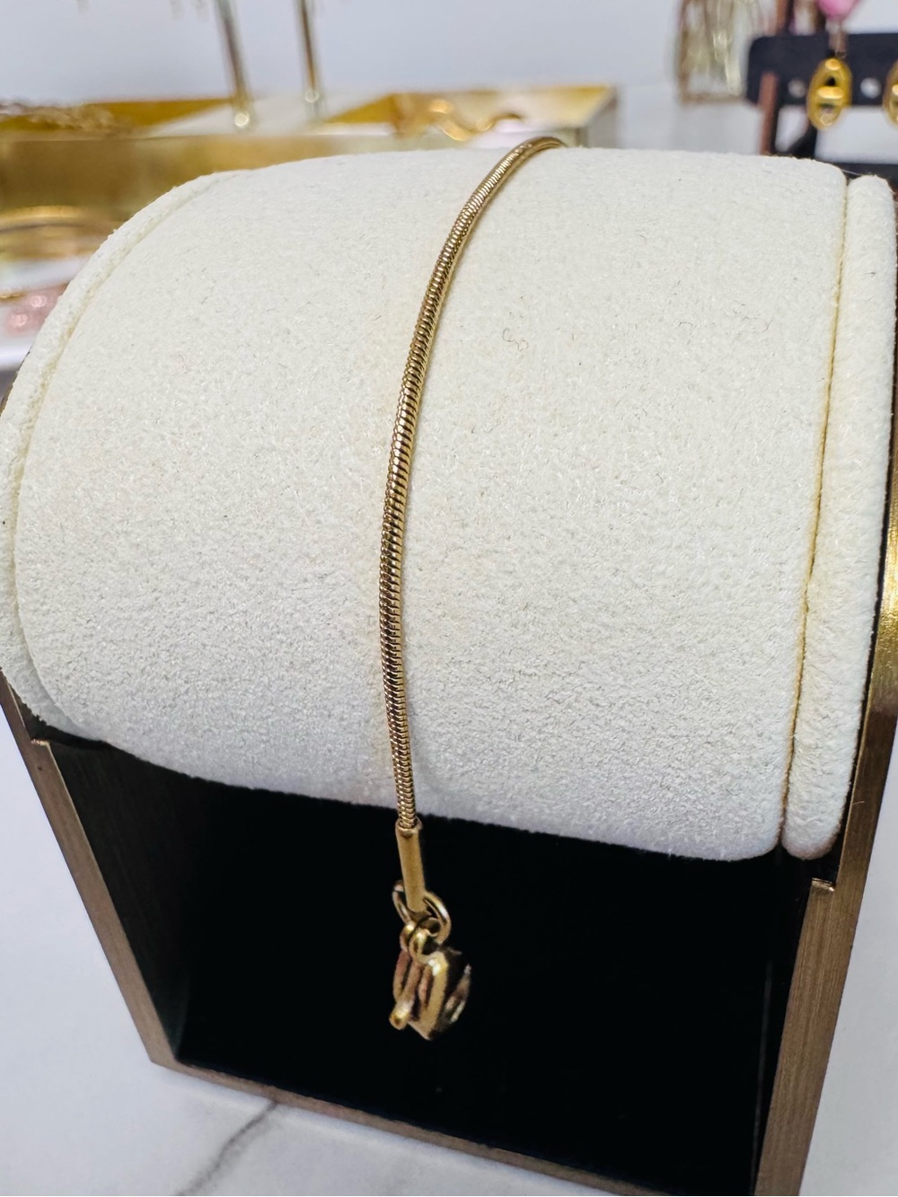 Gold Tone Snake Chain Bracelet with Interlocking Charm